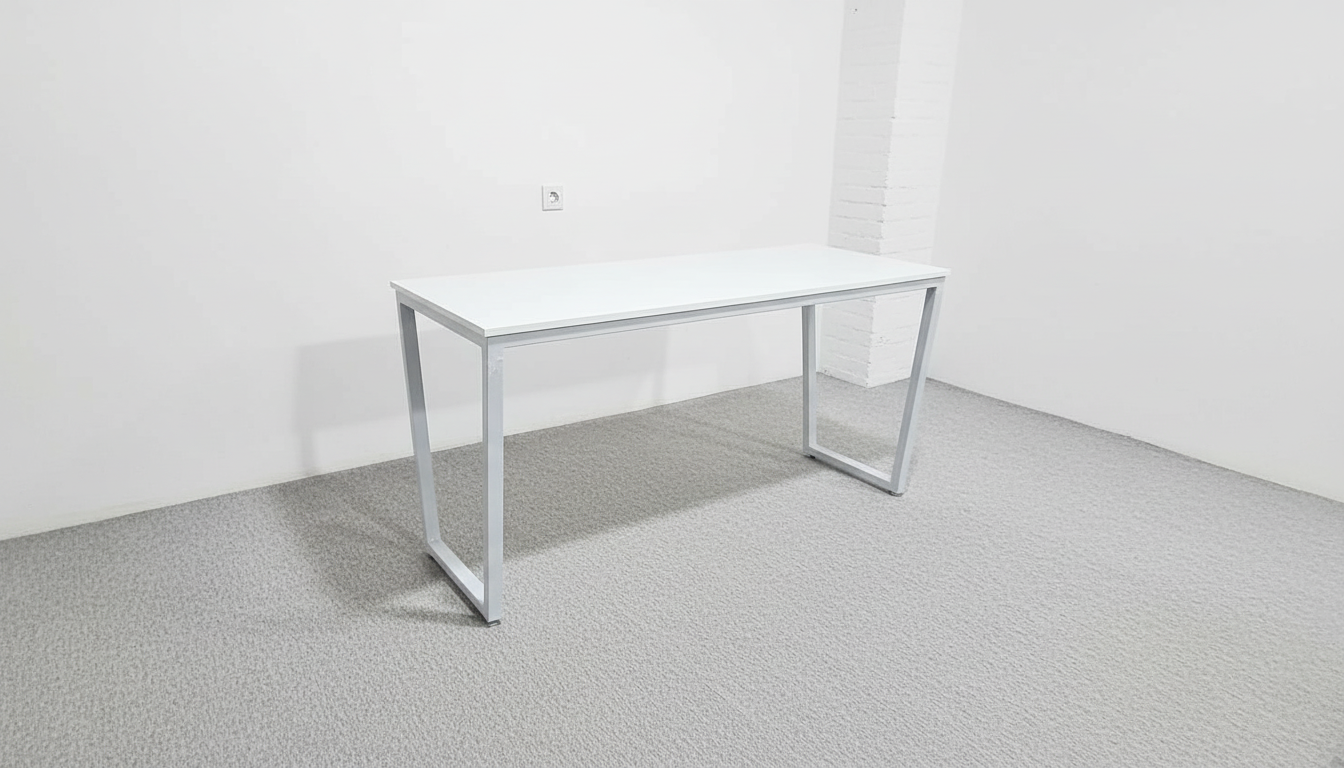 White office desk in a minimalistic room with white walls and gray floor.